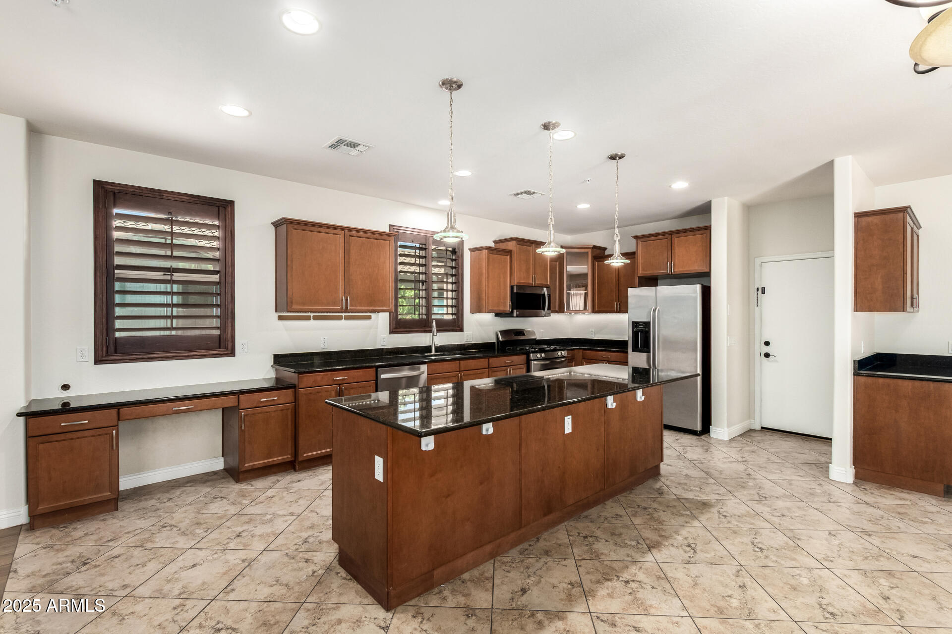 19263 East Estrella Road Queen Creek, AZ 85142 - Photo 7 of 53 a kitchen with stainless steel appliances granite countertop a stove and a sink