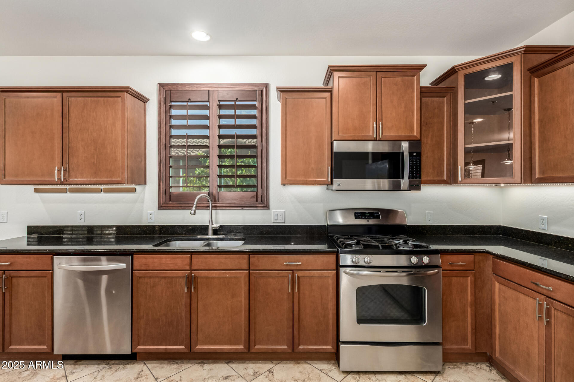 19263 East Estrella Road Queen Creek, AZ 85142 - Photo 10 of 53 a kitchen with granite countertop a stove sink and microwave