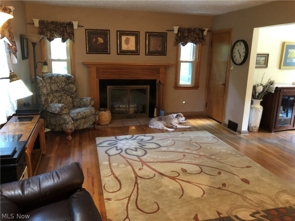 2980 Pontius Road Uniontown, OH 44685 - Photo 12 of 32 Large 20x13 living room with a wonderful fireplace and hardwood floors. Open concept into the dining room. The dog does not stay with the home:)