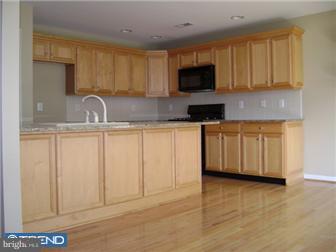 24 Hogan Way Moorestown, NJ 08057 - Photo 5 of 9 a kitchen with stainless steel appliances granite countertop a sink a stove a microwave and cabinets