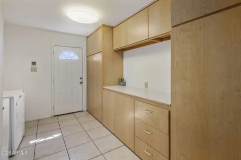 a utility room with cabinets washer and dryer