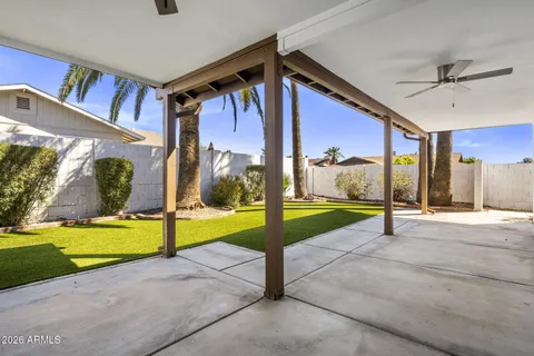 a view of a house with a backyard