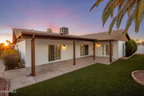 an empty room with closet and a ceiling fan