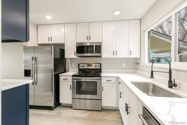 a kitchen with a sink stove and refrigerator