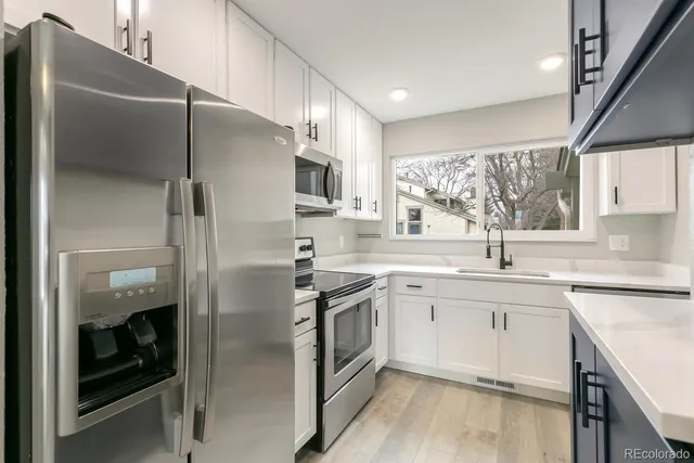 a kitchen with a sink stove and cabinets