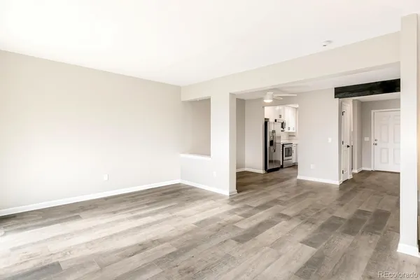 an empty room with a fireplace and cabinet