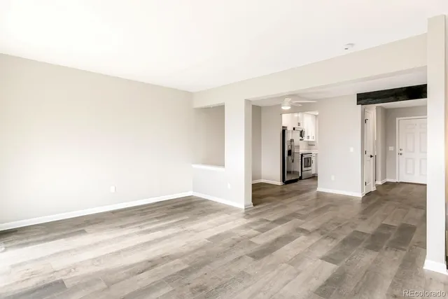an empty room with a fireplace and cabinet
