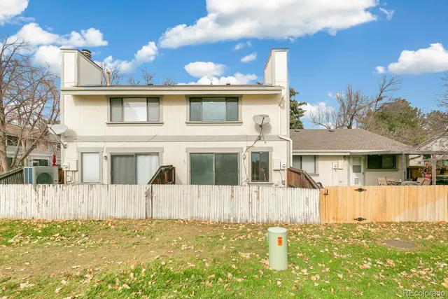 a large building with trees in the background