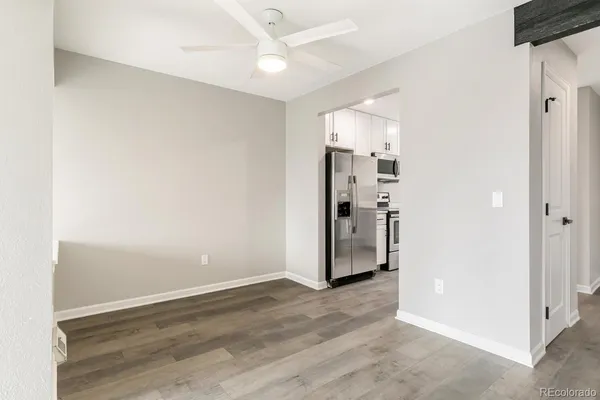 a view of kitchen with stainless steel appliances kitchen island wooden floor and window