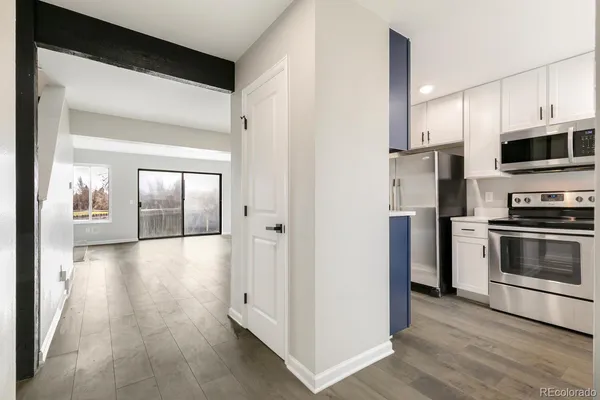 a kitchen with stainless steel appliances granite countertop a refrigerator stove and sink