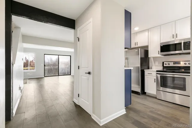 a kitchen with stainless steel appliances granite countertop a refrigerator stove and sink