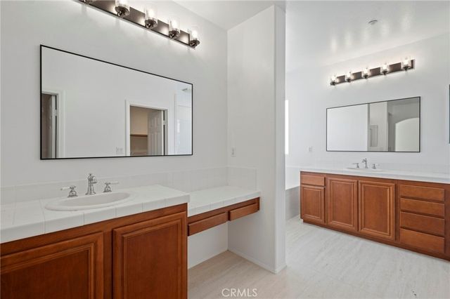 a bathroom with a sink vanity and mirror