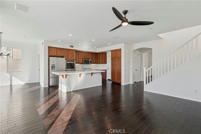 a open kitchen with white cabinets and a refrigerator