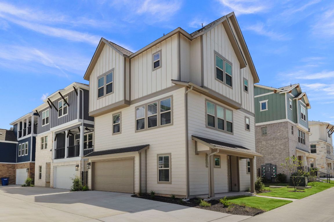6312 Stockman Drive, Unit 6 Austin, TX 78747 - Photo 1 of 35 a view of a white building among the street with large windows