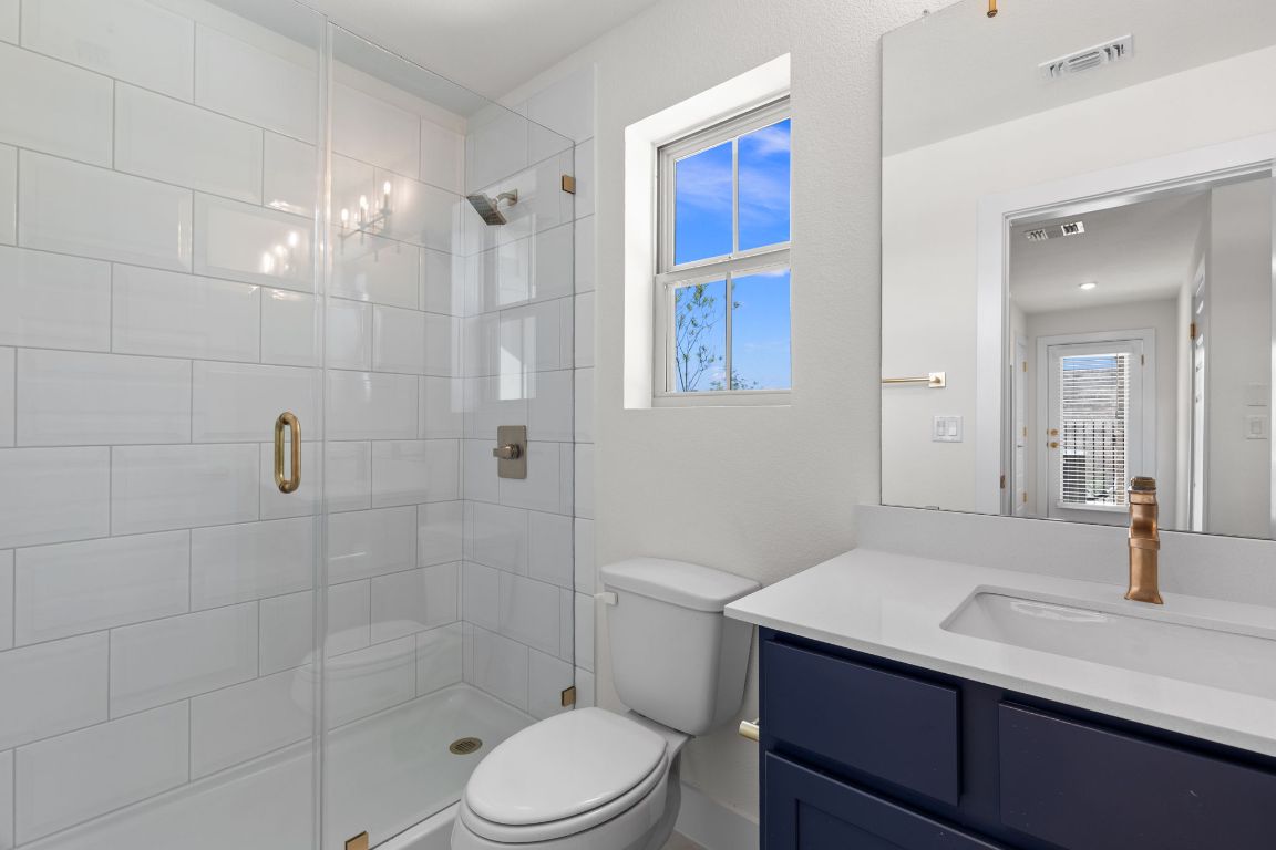 6312 Stockman Drive, Unit 6 Austin, TX 78747 - Photo 13 of 35 a bathroom with a sink a toilet and shower