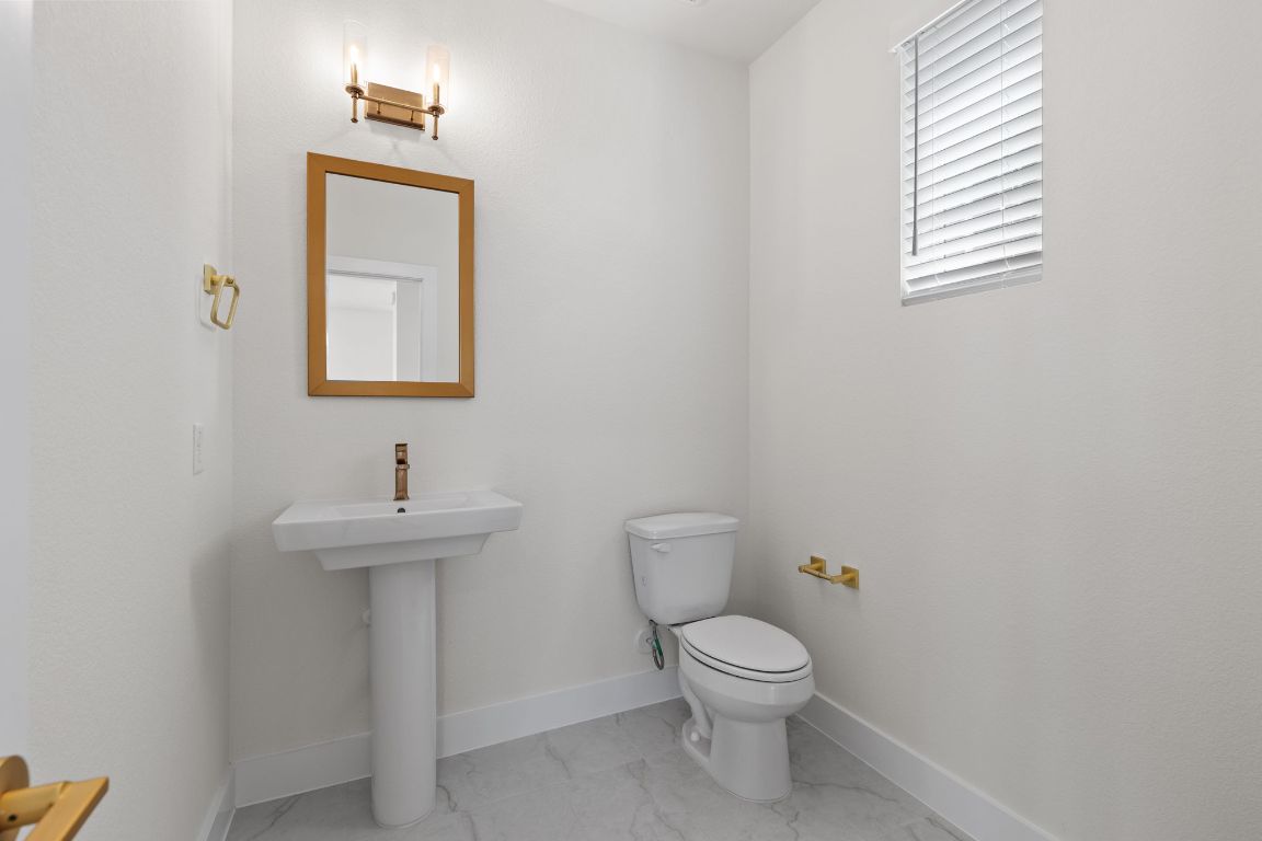 6312 Stockman Drive, Unit 6 Austin, TX 78747 - Photo 15 of 35 a bathroom with a toilet sink and mirror