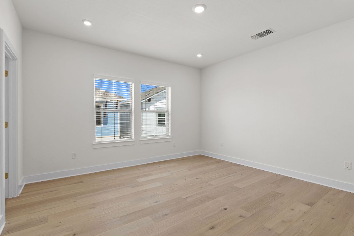 6312 Stockman Drive, Unit 6 Austin, TX 78747 - Photo 23 of 35 a view of empty room with wooden floor and fan