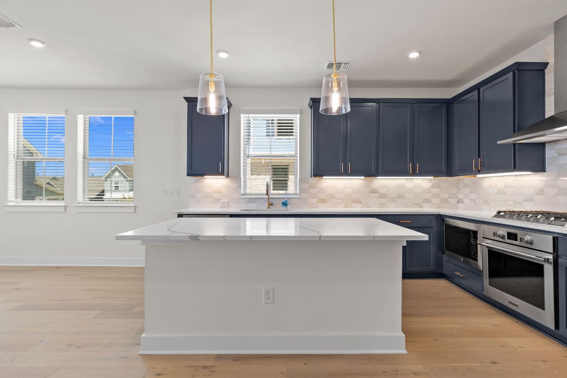 6312 Stockman Drive, Unit 6 Austin, TX 78747 - Photo 4 of 35 a kitchen with kitchen island stainless steel appliances a sink stove and cabinets