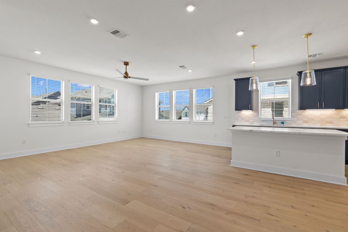 6312 Stockman Drive, Unit 6 Austin, TX 78747 - Photo 8 of 35 a view of an empty room with a window and wooden floor