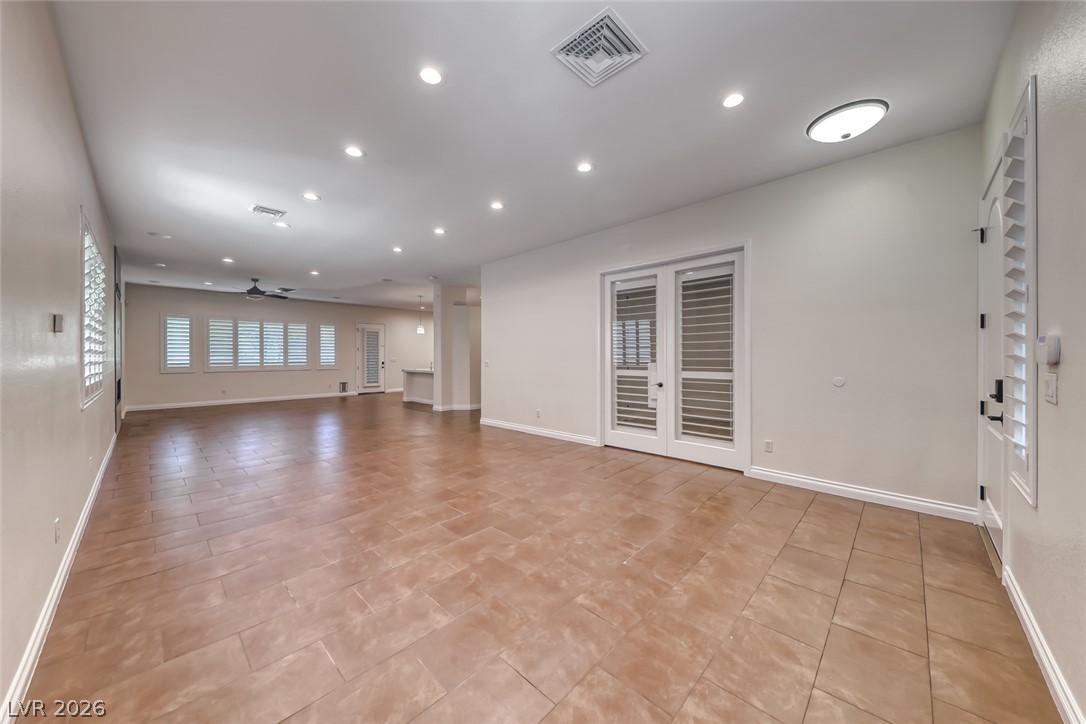 2122 Mooreview Street Henderson, NV 89012 - Photo 4 of 44 A spacious common area offers ample room for living and entertaining, featuring tiled flooring throughout.