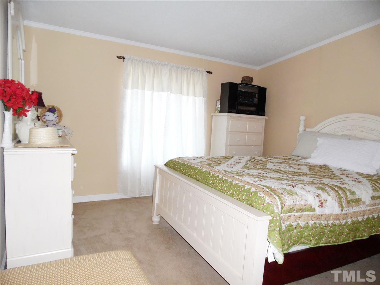 15 Rhode Island Way Cameron, NC 28326 - Photo 11 of 17 a bedroom with a bed and a flat screen tv