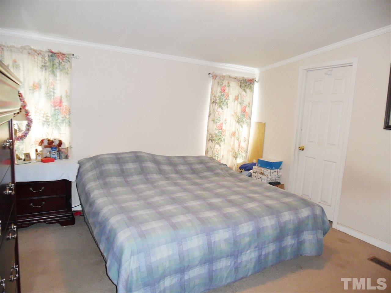 15 Rhode Island Way Cameron, NC 28326 - Photo 13 of 17 a bedroom with a bed and a window