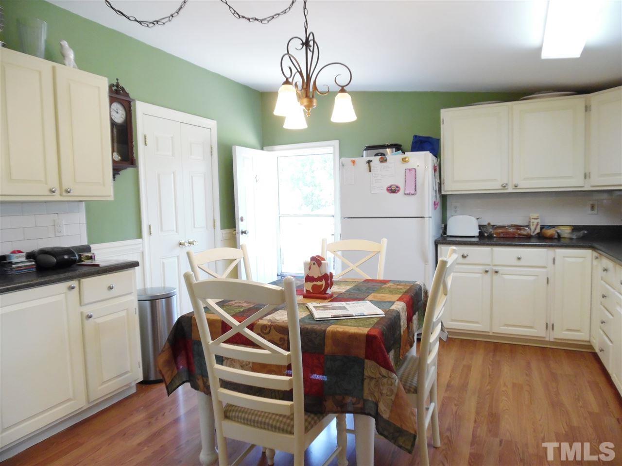 15 Rhode Island Way Cameron, NC 28326 - Photo 6 of 17 a kitchen with stainless steel appliances granite countertop a stove a sink dishwasher and a refrigerator with wooden floor