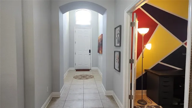 a view of a hallway with wooden floor and a door