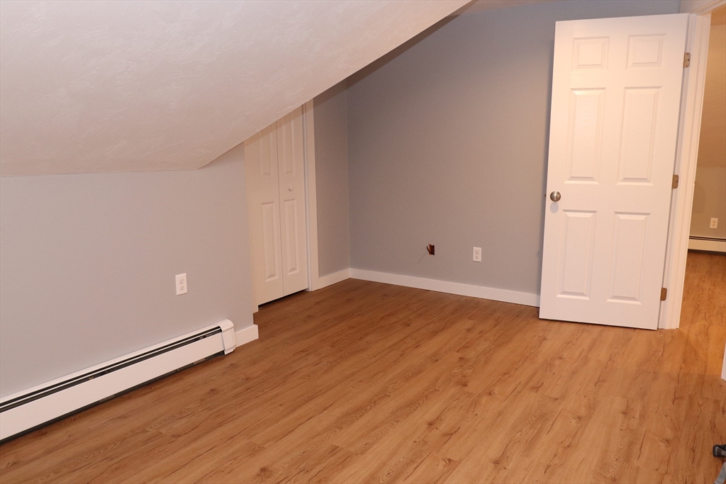 73 Everett Street, Unit 3 Middleboro, MA 02346 - Photo 12 of 17 an empty room with wooden floor