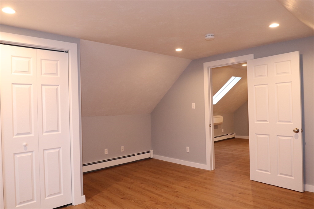 73 Everett Street, Unit 3 Middleboro, MA 02346 - Photo 16 of 17 an empty room with wooden floor and a window