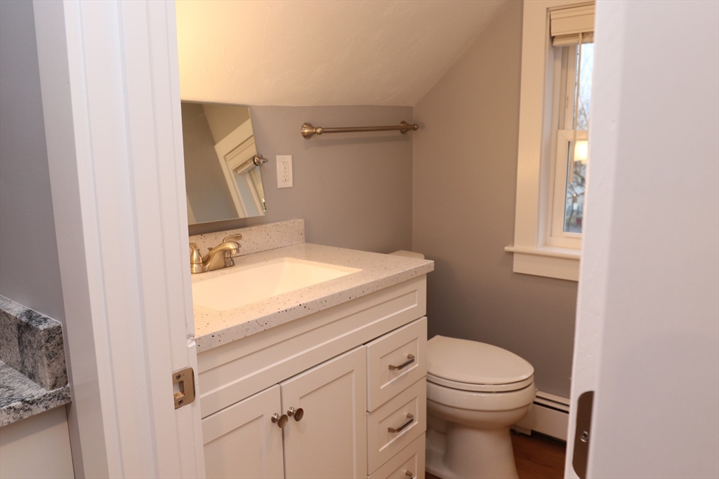 73 Everett Street, Unit 3 Middleboro, MA 02346 - Photo 4 of 17 a bathroom with a sink a toilet and vanity