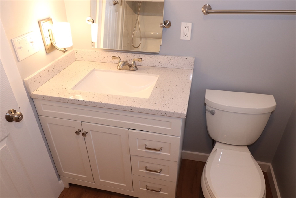 73 Everett Street, Unit 3 Middleboro, MA 02346 - Photo 6 of 17 a bathroom with a toilet sink and mirror
