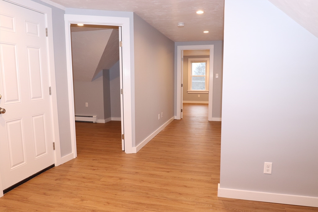 73 Everett Street, Unit 3 Middleboro, MA 02346 - Photo 7 of 17 a view of a hallway with wooden floor