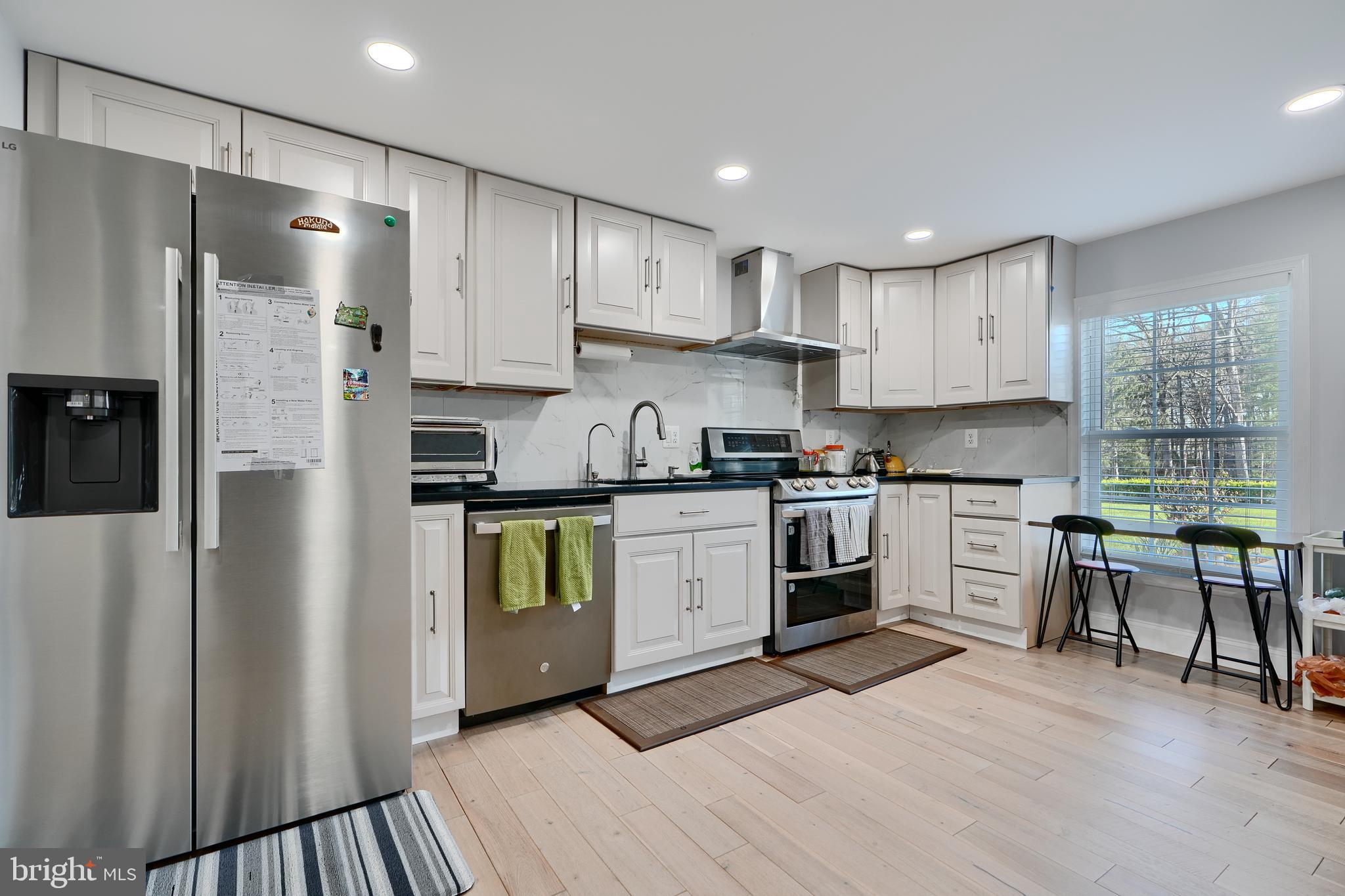 12330 Scaggsville Road Fulton, MD 20759 - Photo 14 of 40 a kitchen with a refrigerator a sink and wooden cabinets