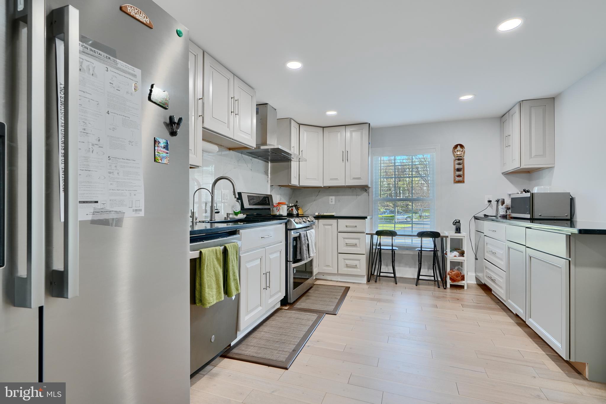 12330 Scaggsville Road Fulton, MD 20759 - Photo 15 of 40 a kitchen with white cabinets and stainless steel appliances