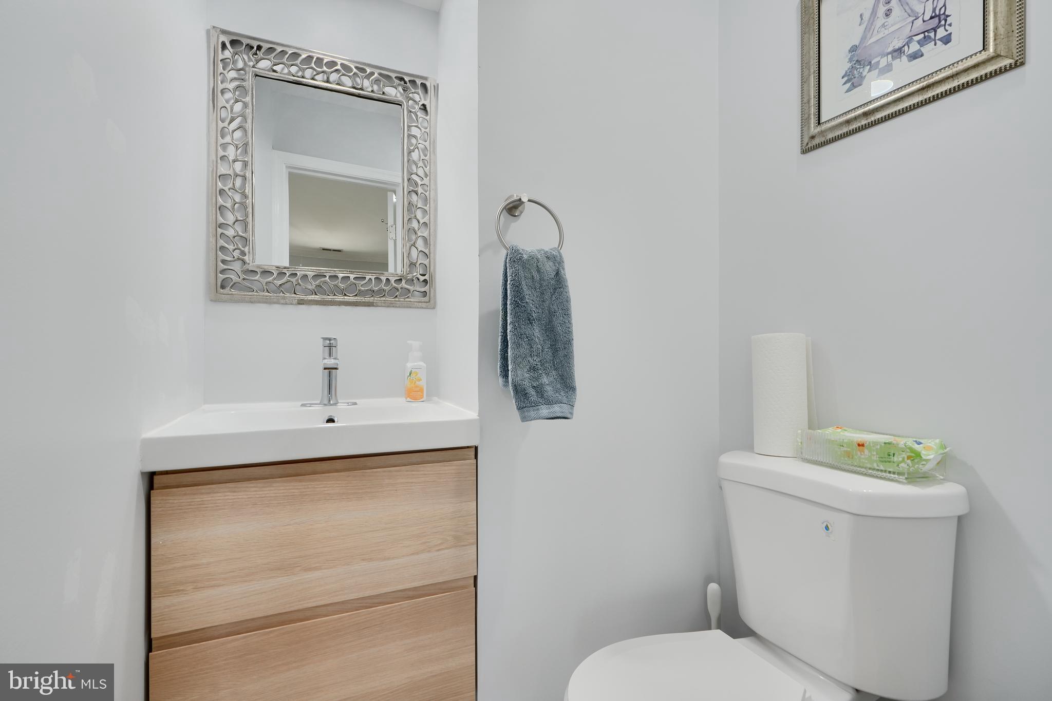 12330 Scaggsville Road Fulton, MD 20759 - Photo 17 of 40 a bathroom with a toilet sink vanity and mirror