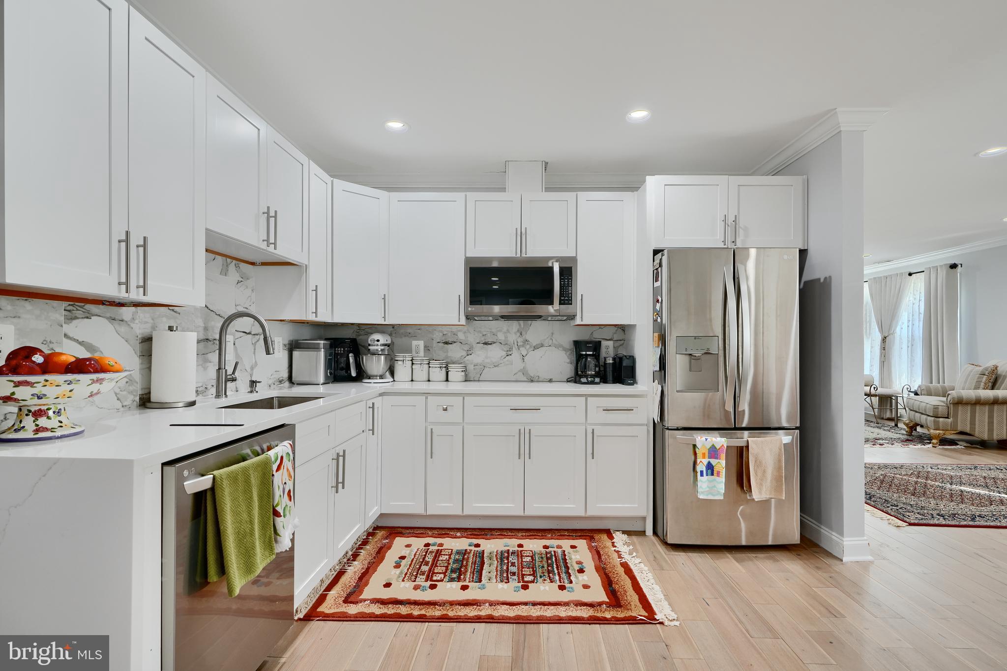 12330 Scaggsville Road Fulton, MD 20759 - Photo 10 of 40 a kitchen with a refrigerator a stove top oven a sink and cabinets