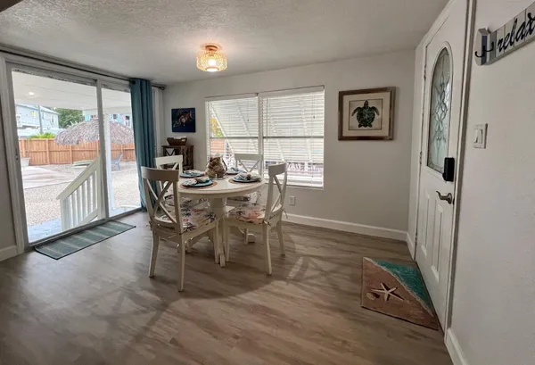 a view of a dining room with furniture large window and wooden floor
