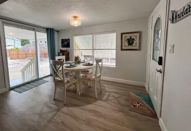 a view of a dining room with furniture large window and wooden floor