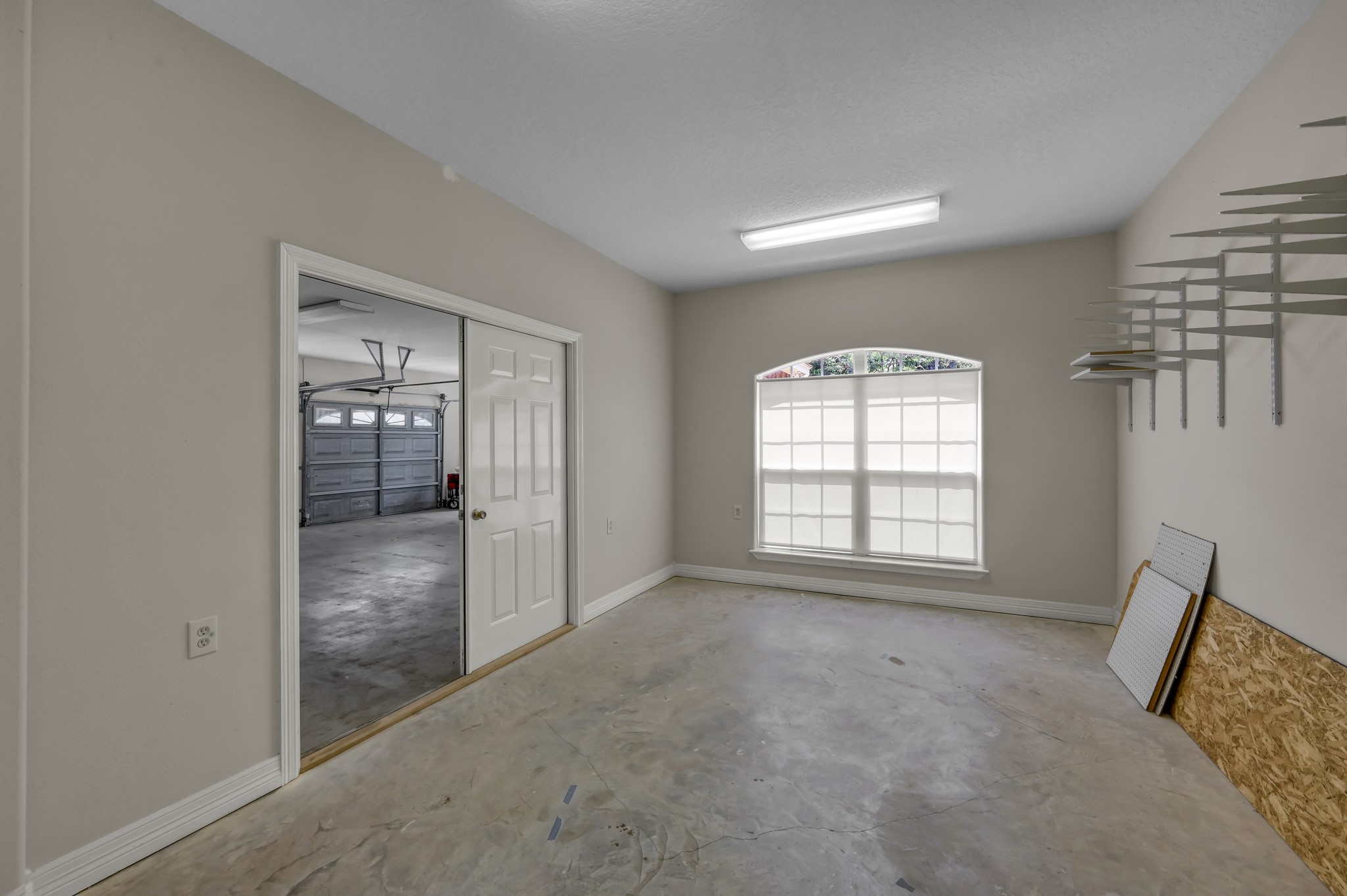 9606 Miller Road Magnolia, TX 77354 - Photo 30 of 41 Check out this workshop! Double doors to the garage, an entry door to the home and its own zone control for HVAC