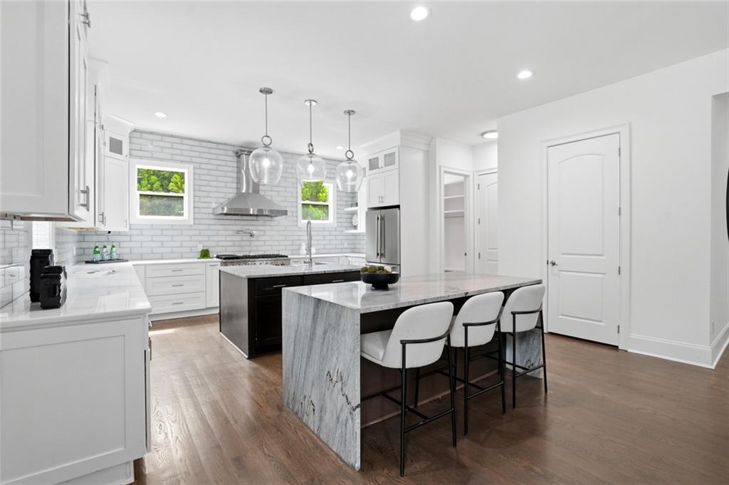 2415 West Rugby Avenue Atlanta, GA 30337 - Photo 8 of 40 a kitchen with granite countertop white cabinets and appliances