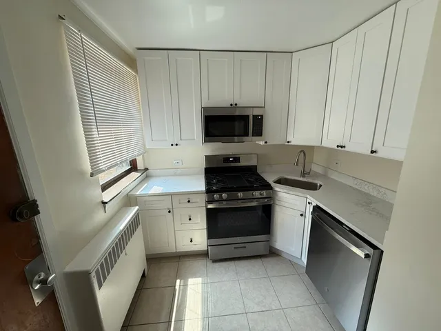 a kitchen with a sink stove and cabinets