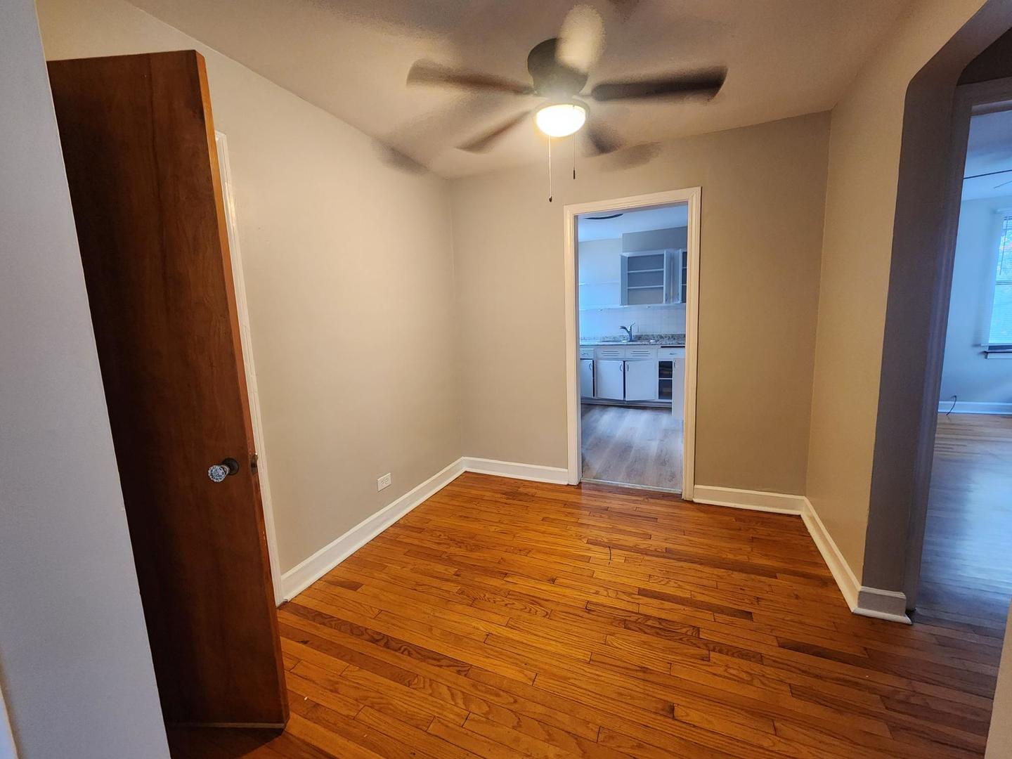 7375 North Winchester Avenue, Unit 1W Chicago, IL 60626 - Photo 5 of 8 an empty room with wooden floor and closet area