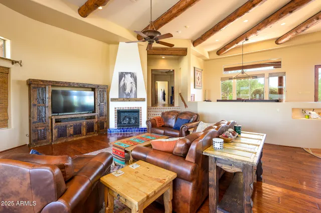 a living room with furniture fireplace and a table