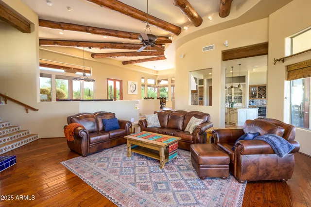 a living room with a table chairs and a rug