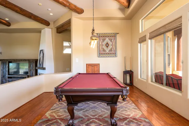 a view of a dining room with furniture a chandelier and wooden floor