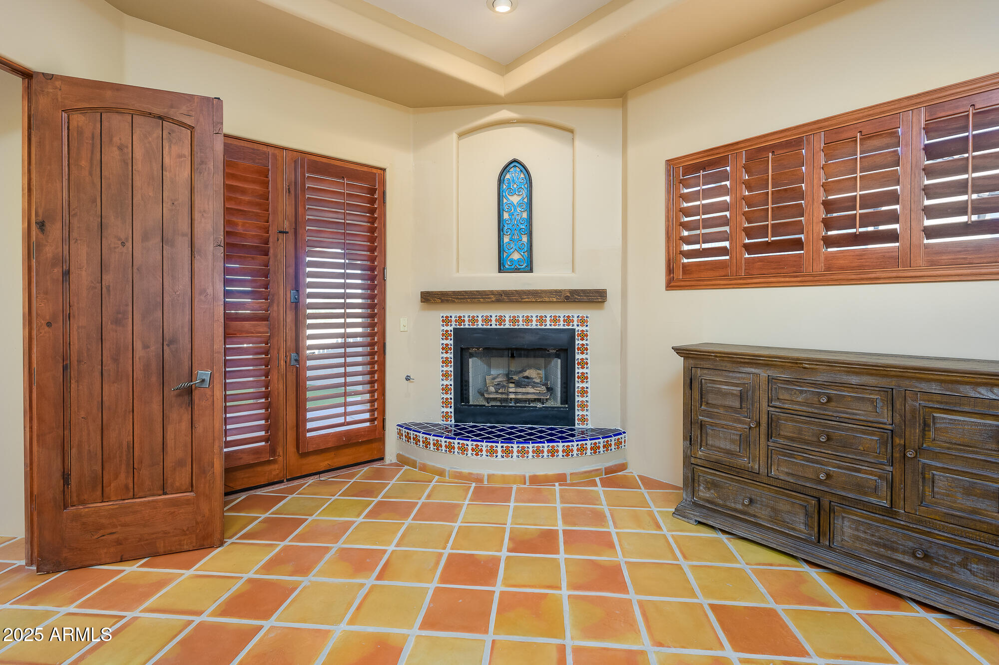 8540 East McDowell Road, Unit 29 Mesa, AZ 85207 - Photo 18 of 59 a view of an empty room with a fireplace and cabinet