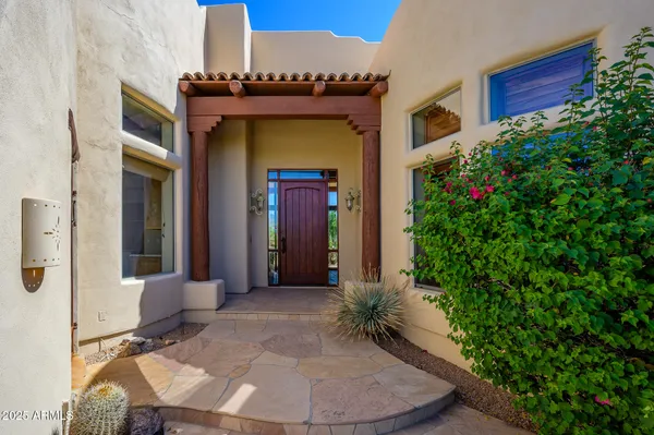 a view of a house with a flower garden