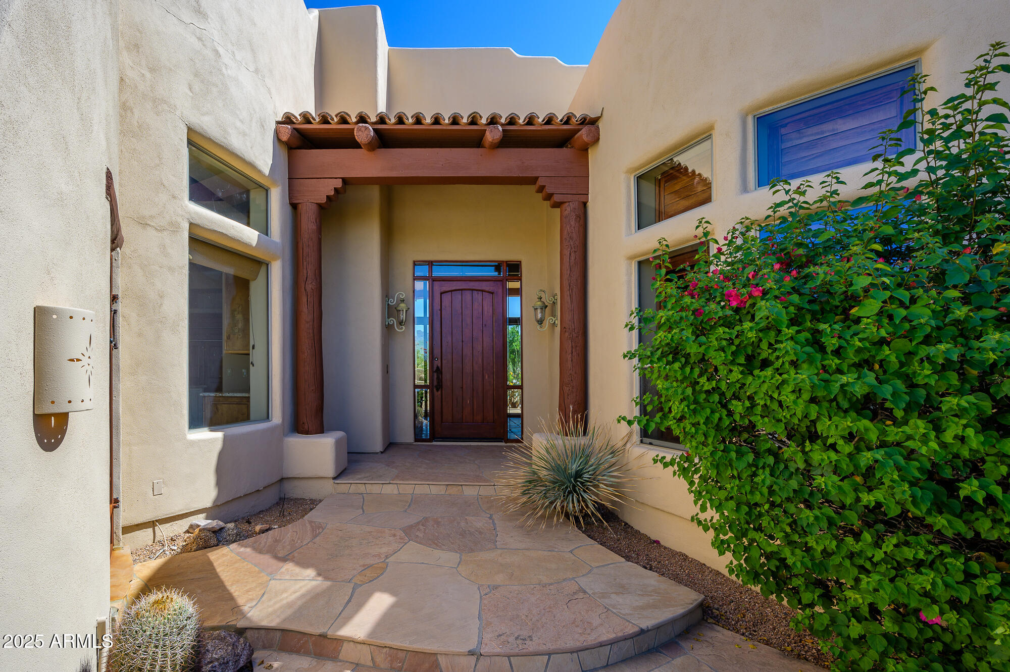 8540 East McDowell Road, Unit 29 Mesa, AZ 85207 - Photo 2 of 59 a view of a house with a flower garden
