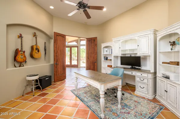 a bedroom with a bed and dresser with mirror